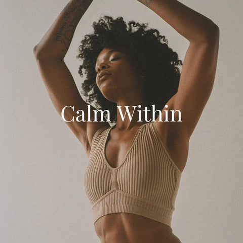 A serene Black woman with natural curls poses with arms gracefully raised above her head, wearing a ribbed taupe sports bra. Her eyes are closed, embodying tranquility and self-connection. Overlaid white serif text reads “Calm Within.”